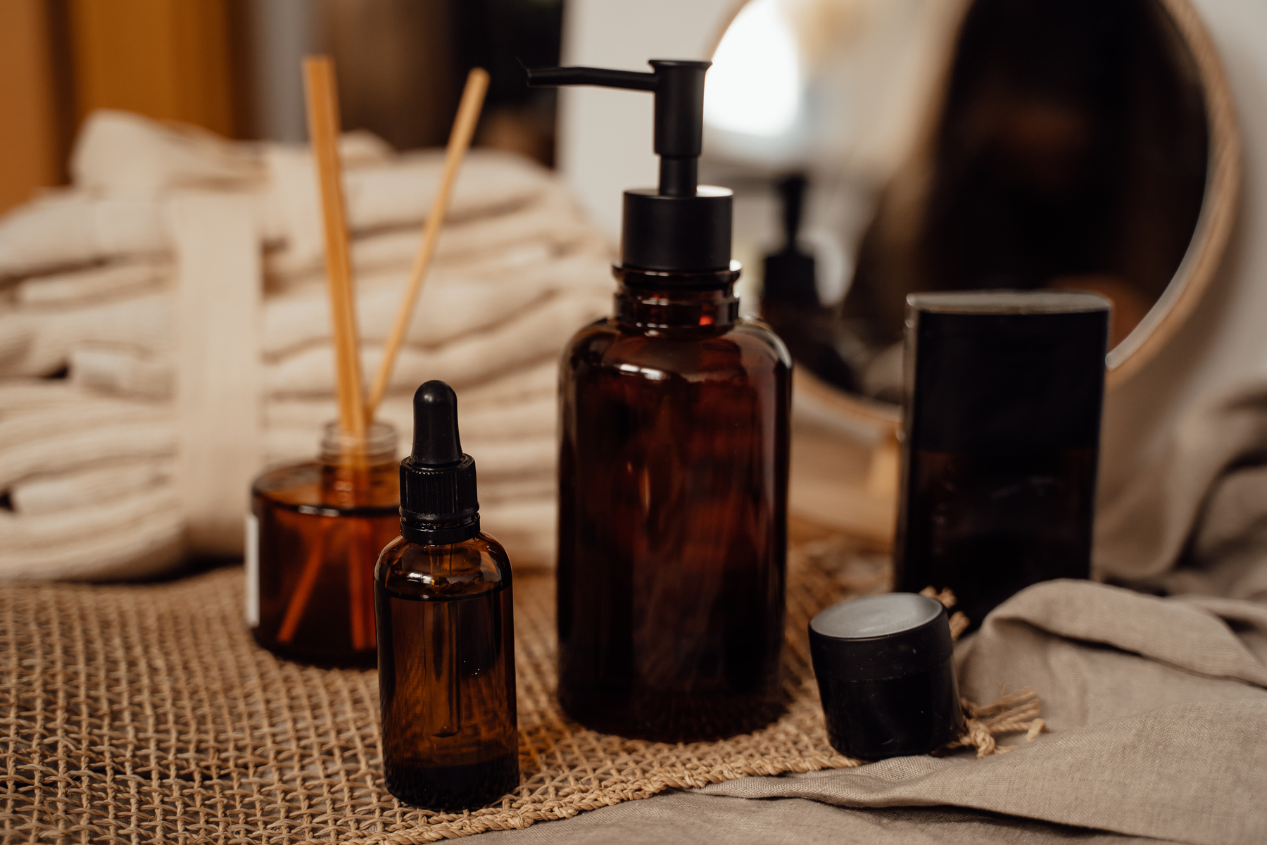 Brown Glass Bottle on Brown Textile
